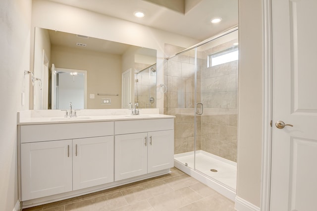 bathroom featuring an enclosed shower, vanity, and tile patterned floors