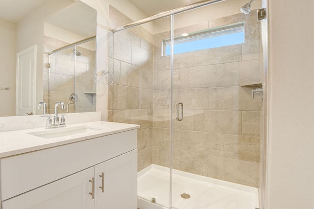 bathroom featuring an enclosed shower and vanity