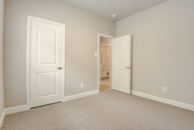 unfurnished bedroom featuring light colored carpet