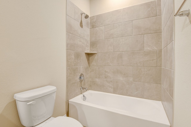 bathroom with tiled shower / bath combo and toilet