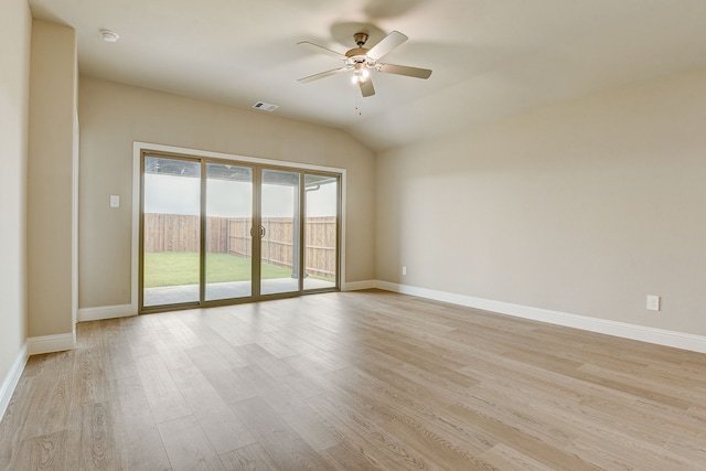 empty room featuring lofted ceiling, ceiling fan, and light hardwood / wood-style flooring