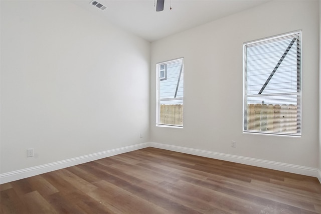 empty room with hardwood / wood-style flooring and ceiling fan