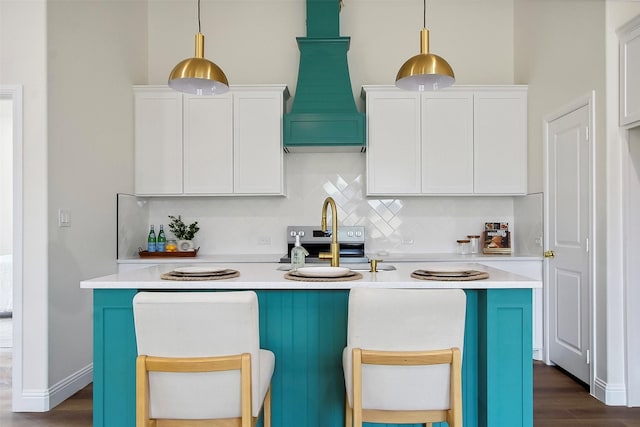 kitchen featuring pendant lighting, decorative backsplash, and white cabinets