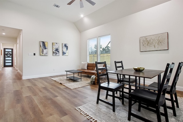 dining area with vaulted ceiling, ceiling fan, and light hardwood / wood-style floors