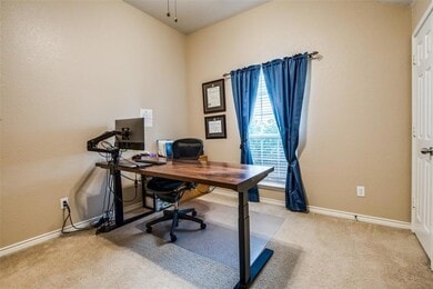 carpeted home office featuring ceiling fan and lofted ceiling