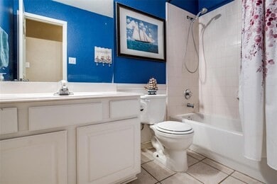 full bathroom featuring sink, tile patterned floors, toilet, and shower / tub combo