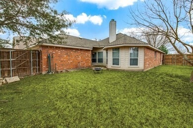 rear view of property with a lawn