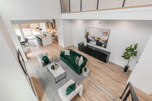 living room with hardwood / wood-style floors and a high ceiling