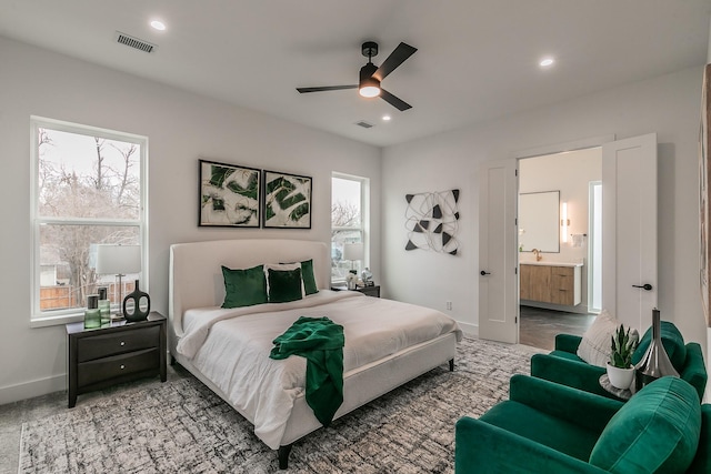 bedroom with multiple windows, carpet floors, ceiling fan, and ensuite bathroom