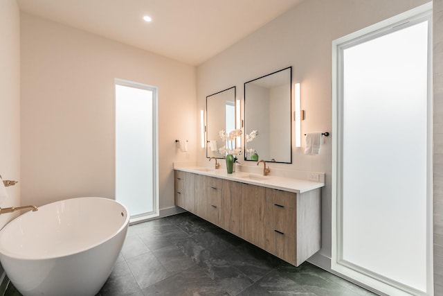 bathroom featuring a washtub and vanity