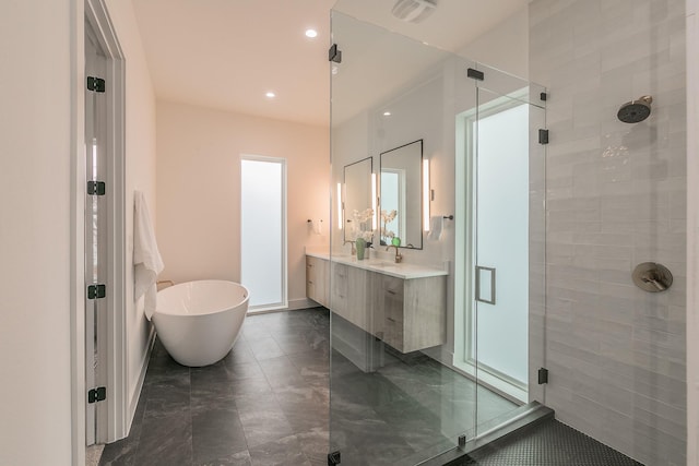 bathroom with independent shower and bath and vanity