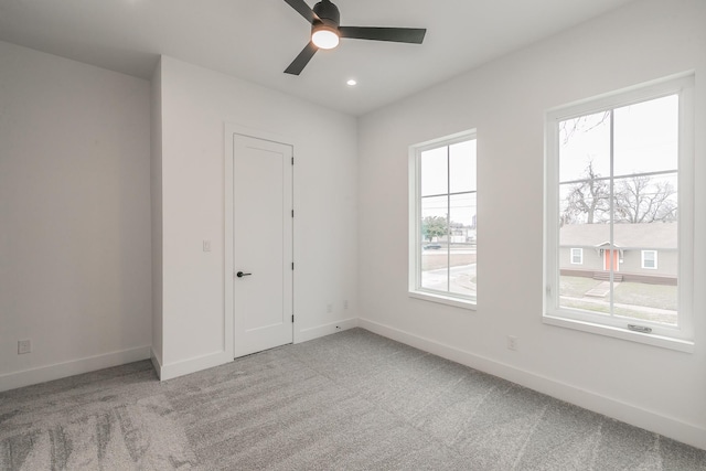 carpeted empty room featuring ceiling fan