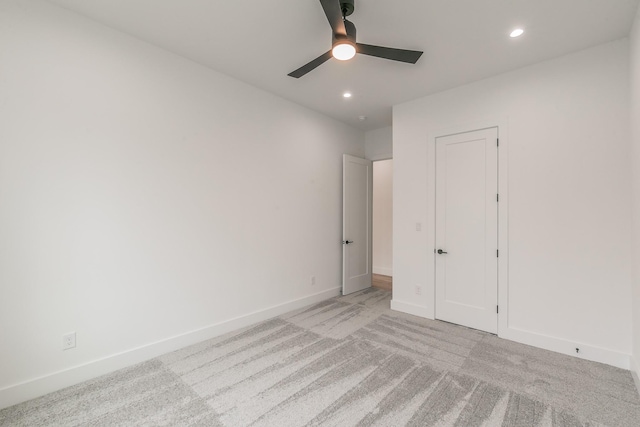 unfurnished bedroom with light carpet and ceiling fan