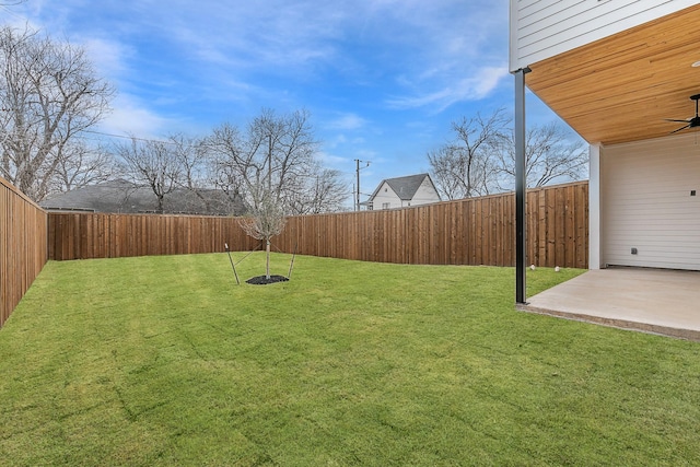 view of yard with ceiling fan and a patio area