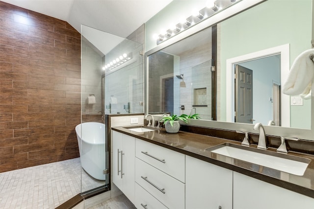 bathroom featuring tile patterned floors, lofted ceiling, plus walk in shower, and vanity