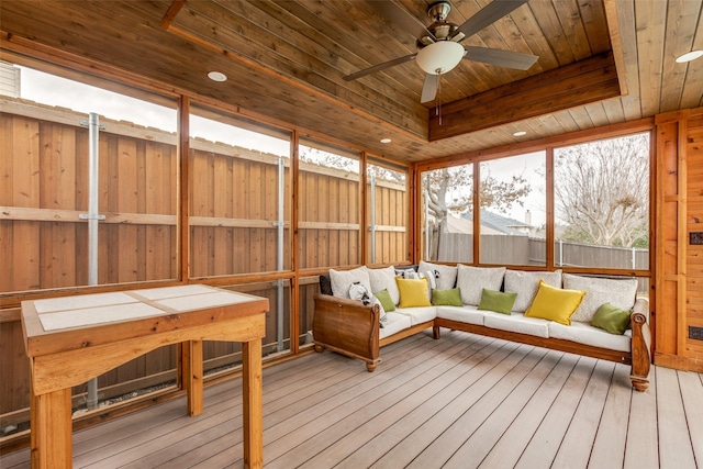 sunroom / solarium with wooden ceiling, ceiling fan, and a tray ceiling