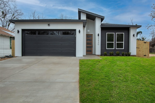 modern home with a garage and a front lawn