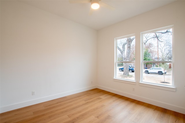 empty room with ceiling fan and light hardwood / wood-style floors