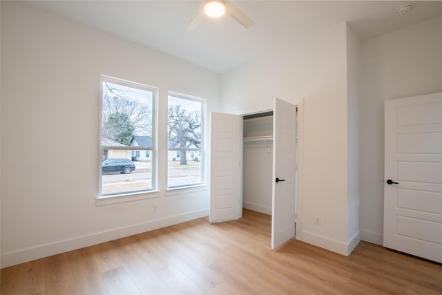 unfurnished bedroom with ceiling fan, light hardwood / wood-style floors, and a closet