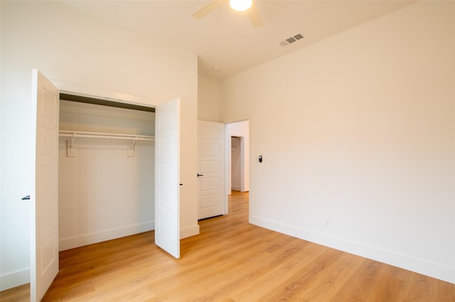 unfurnished bedroom with a closet, ceiling fan, and light wood-type flooring