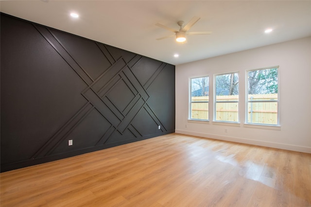 unfurnished room featuring ceiling fan and light wood-type flooring