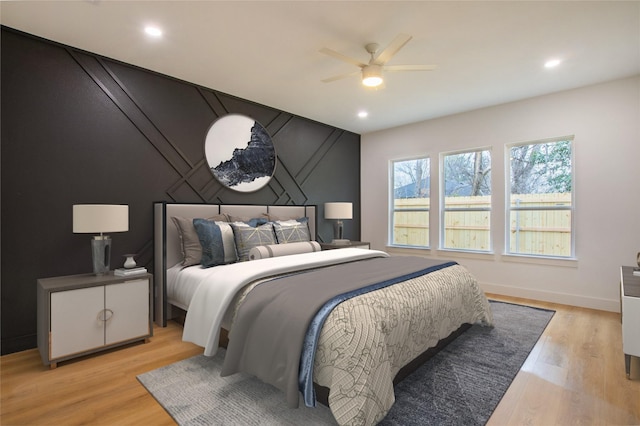 bedroom featuring ceiling fan and light hardwood / wood-style flooring