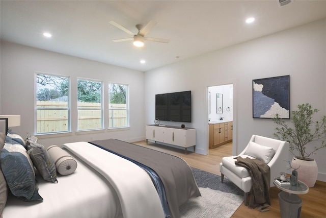 bedroom featuring ensuite bathroom, ceiling fan, and light hardwood / wood-style flooring