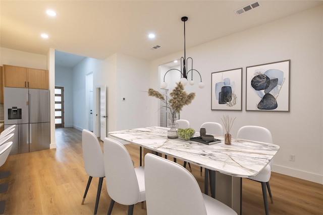 dining area with light hardwood / wood-style floors