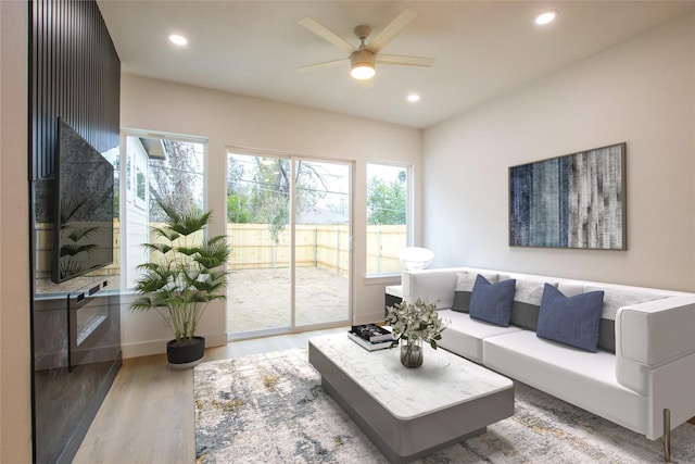 living room featuring ceiling fan and hardwood / wood-style floors