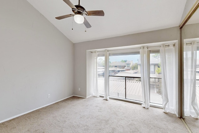 carpeted spare room featuring ceiling fan and vaulted ceiling