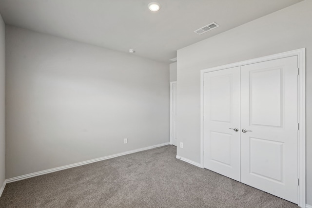 unfurnished bedroom with carpet floors and a closet