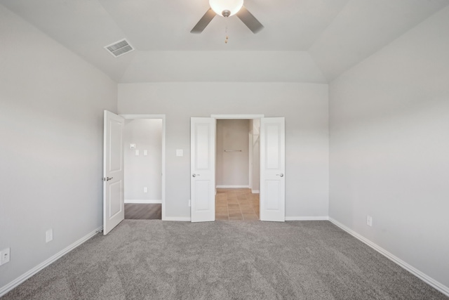 unfurnished bedroom with light carpet, vaulted ceiling, and ceiling fan