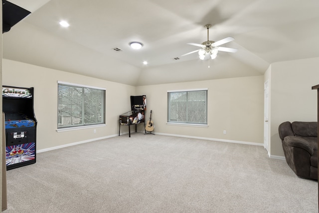 sitting room with lofted ceiling, light carpet, and ceiling fan