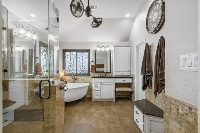 bathroom featuring vanity, lofted ceiling, and shower with separate bathtub