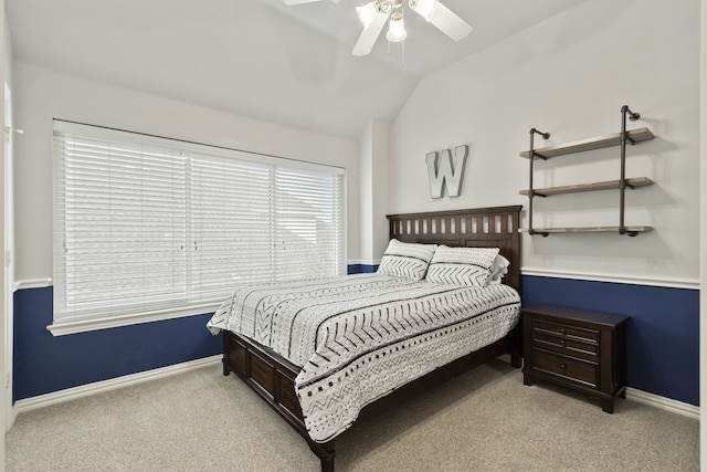 carpeted bedroom with ceiling fan and lofted ceiling