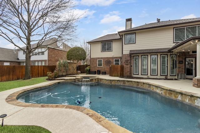 view of swimming pool featuring a patio and an in ground hot tub