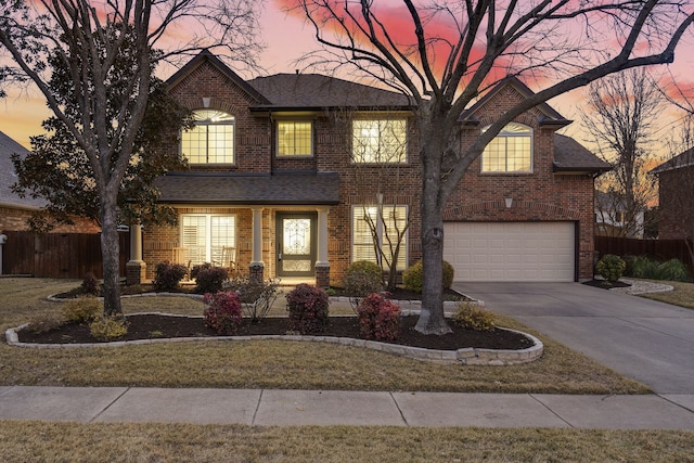 view of front of home featuring a garage and a lawn