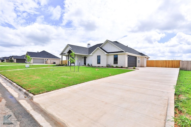 modern inspired farmhouse with a garage and a front lawn