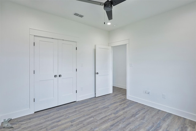 unfurnished bedroom with a closet, ceiling fan, and light wood-type flooring