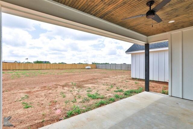 view of yard with ceiling fan and a patio area