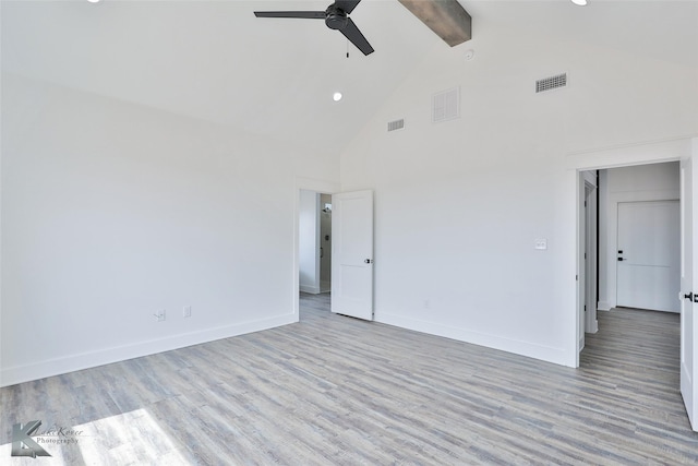 empty room featuring beamed ceiling, ceiling fan, high vaulted ceiling, and light wood-type flooring