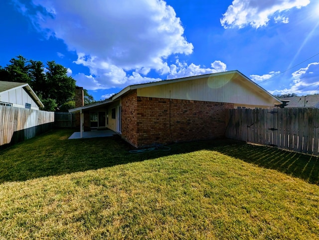 exterior space featuring a patio area and a lawn