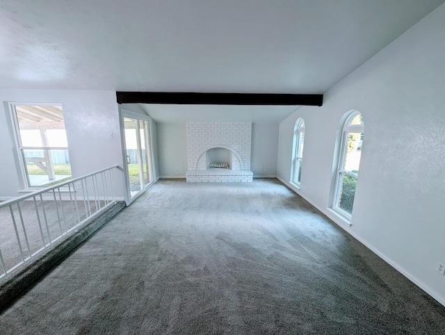 unfurnished living room featuring a brick fireplace, vaulted ceiling with beams, and carpet flooring