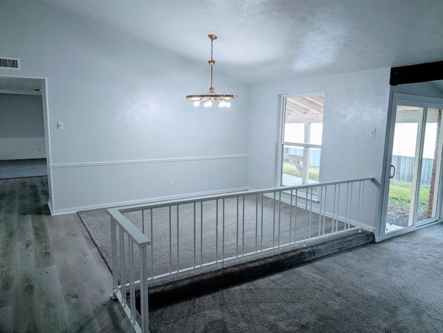 stairs featuring an inviting chandelier and hardwood / wood-style flooring