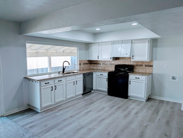 kitchen featuring white cabinetry, sink, light hardwood / wood-style flooring, and black appliances