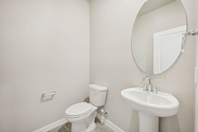 bathroom featuring sink, tile patterned floors, and toilet