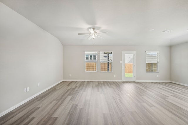 unfurnished living room featuring ceiling fan, light hardwood / wood-style floors, and a wealth of natural light