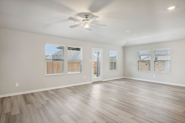 empty room with ceiling fan and light wood-type flooring