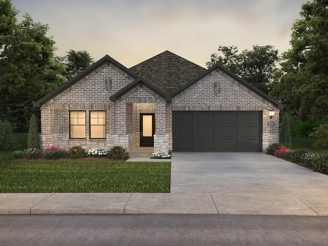 view of front of property with a garage and a lawn