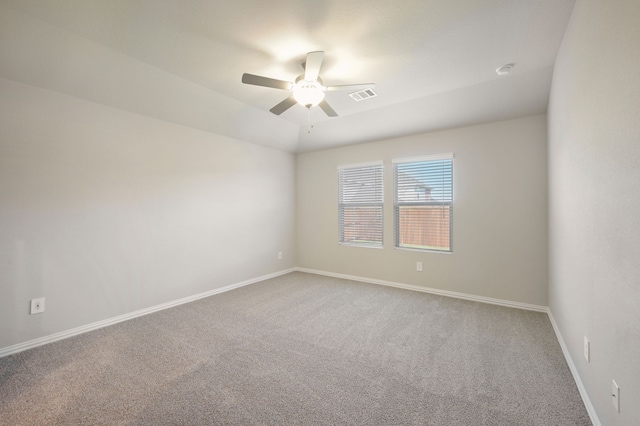 carpeted spare room featuring ceiling fan